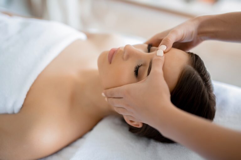 woman getting a massage and med spa facial at ocean avenue aesthetics